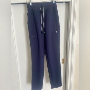 Navy blue high-waisted Yola Figs scrub pants. Size XS, Tall length, skinny fit.